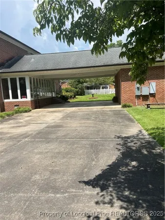 a view of yellow house with a yard