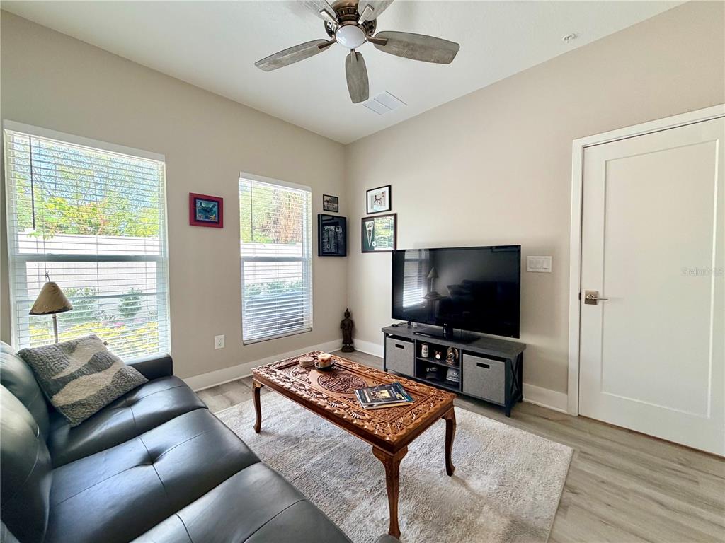 946 Highland Avenue Dunedin, FL 34698 - Photo 13 of 45 a living room with furniture and a flat screen tv
