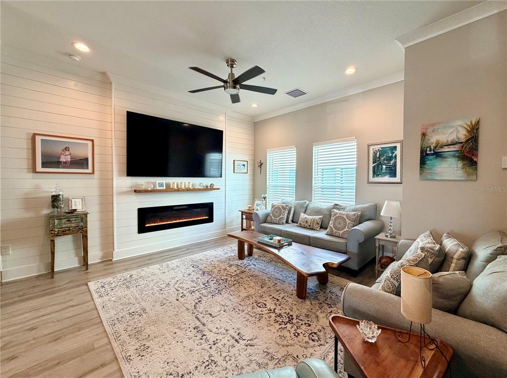 946 Highland Avenue Dunedin, FL 34698 - Photo 20 of 45 a living room with furniture a flat screen tv and a fireplace