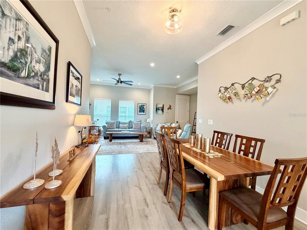 946 Highland Avenue Dunedin, FL 34698 - Photo 21 of 45 a view of a dining room with furniture a chandelier and wooden floor