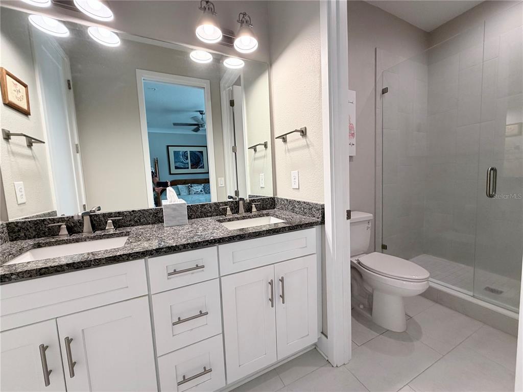 946 Highland Avenue Dunedin, FL 34698 - Photo 28 of 45 a bathroom with a granite countertop toilet sink and a mirror