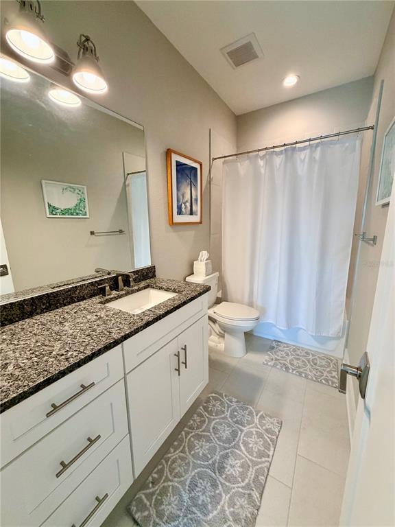 946 Highland Avenue Dunedin, FL 34698 - Photo 34 of 45 a bathroom with a granite countertop sink and a mirror