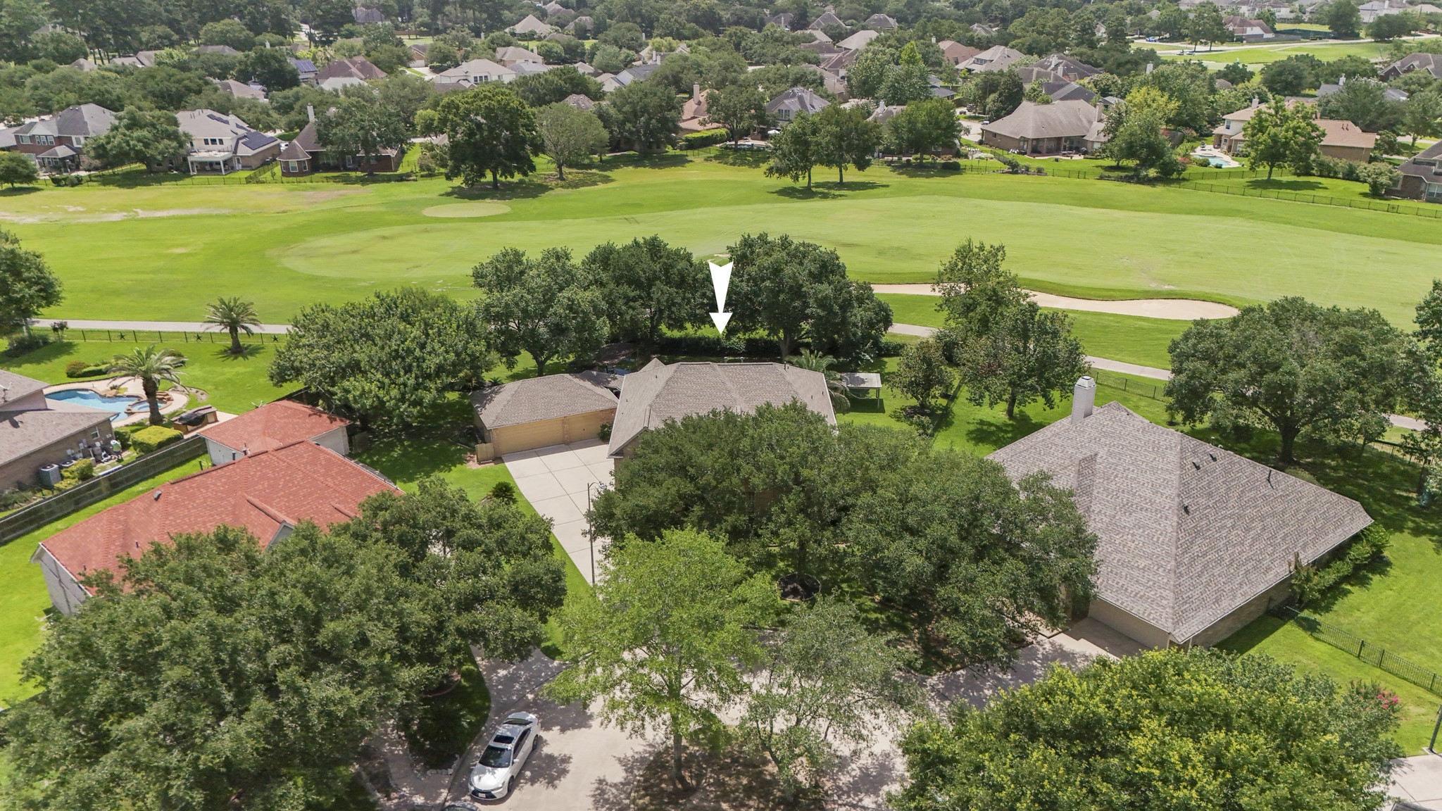 5807 Sequoia Trace Court Spring, TX 77379 - Photo 2 of 50 This aerial view places the home within the Windrose golf course setting, with the fairway and greens just beyond the backyard and mature trees giving the lot a private-feeling backdrop.