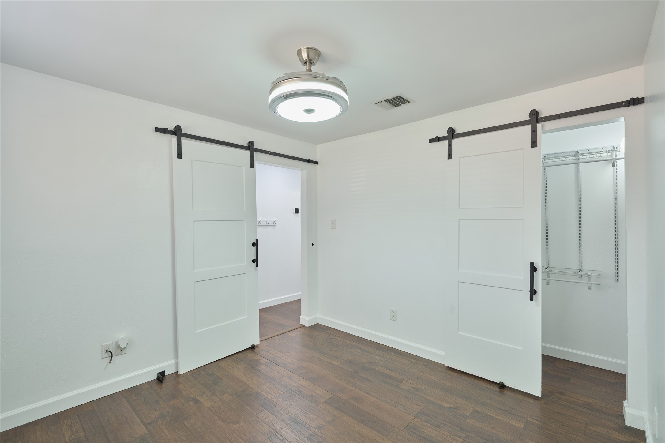 801 River Road, Unit E111 Montgomery, TX 77356 - Photo 13 of 26 Bedroom features barn doors & luxury vinyl floors
