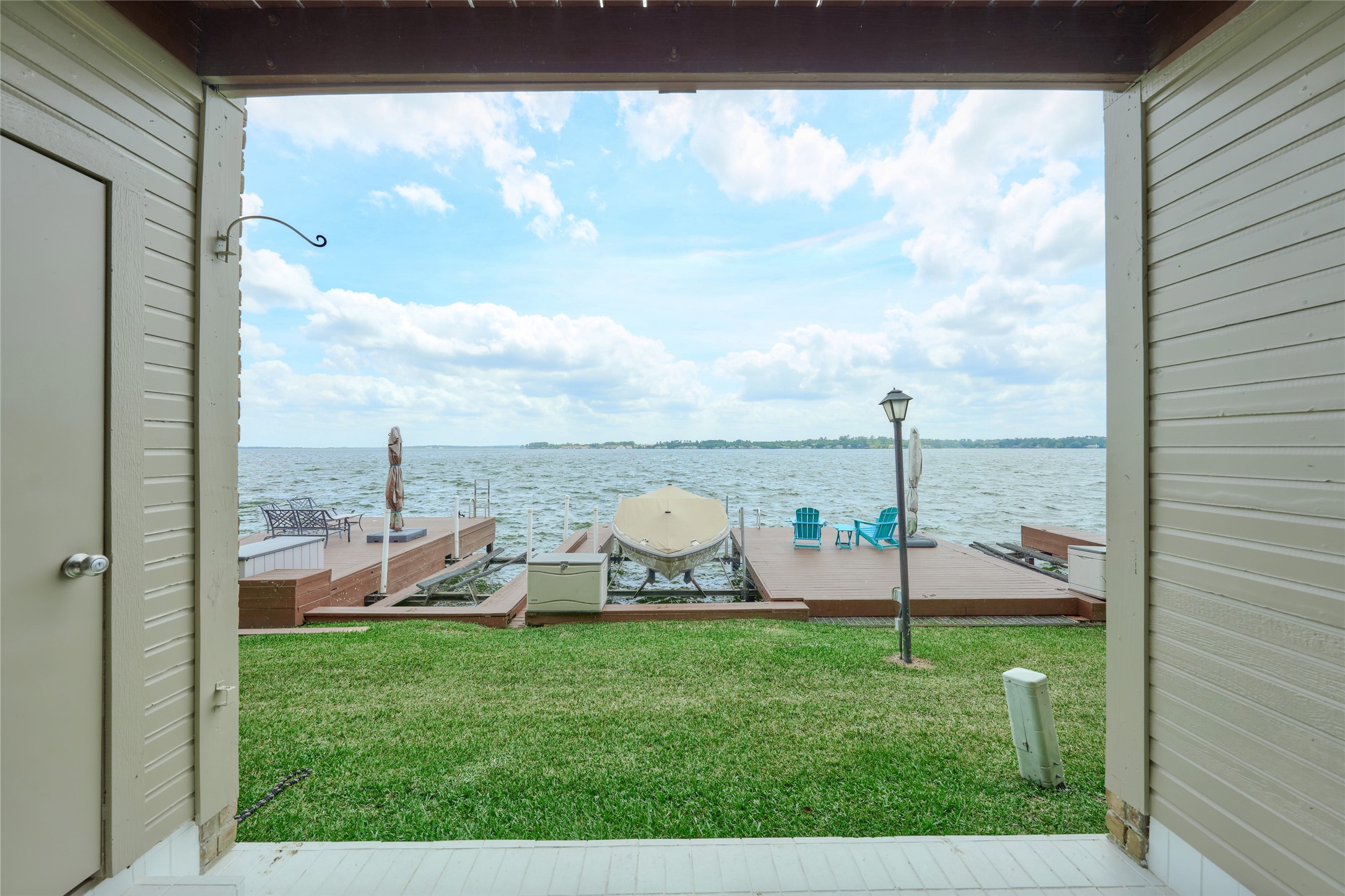801 River Road, Unit E111 Montgomery, TX 77356 - Photo 2 of 26 Exceptional views. Relax on your private covered patio and take in these breathtaking views. Condo has 3 boat slips. One of the slips has a lift just waiting for your boat. Lake Pointe is a gated complex and features a waterside pool.