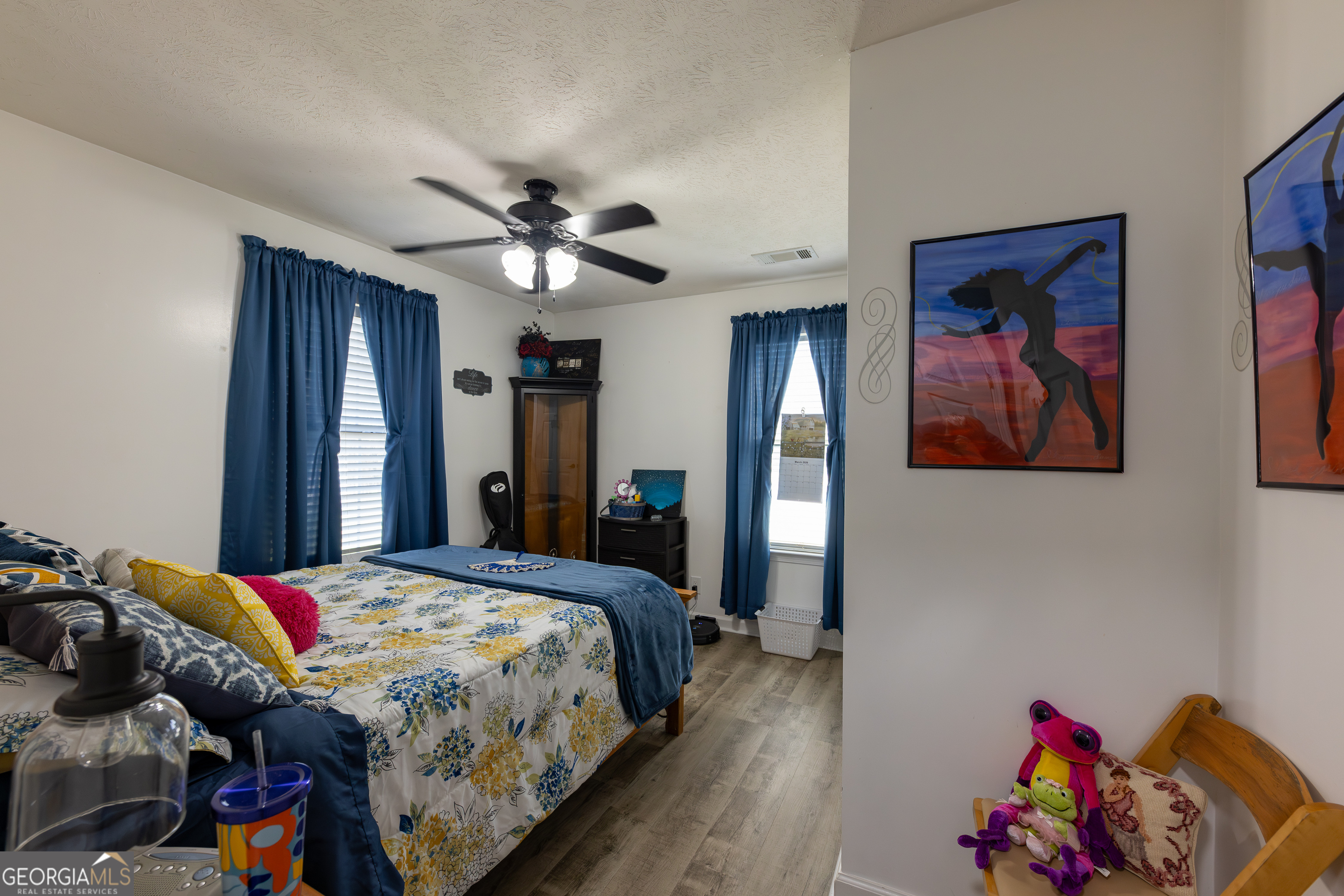 647 Pine Valley Road Meansville, GA 30256 - Photo 18 of 92 a bedroom with bed and a chandelier