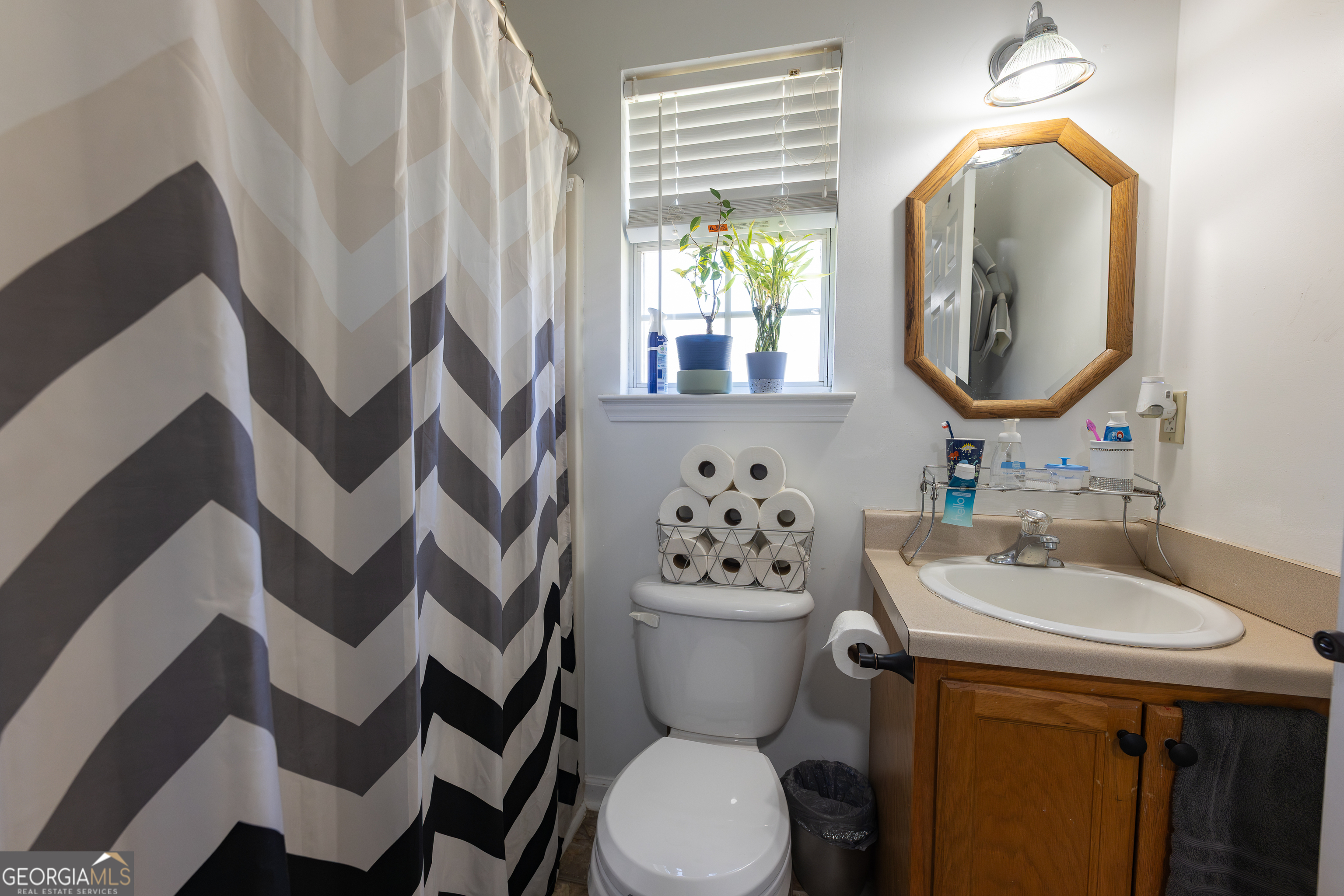 647 Pine Valley Road Meansville, GA 30256 - Photo 20 of 92 a bathroom with a toilet sink and mirror