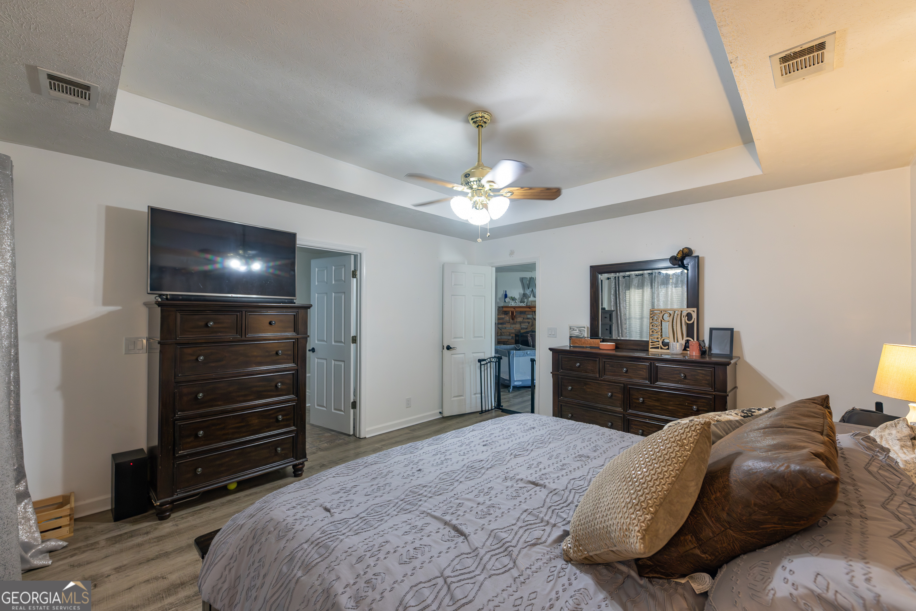 647 Pine Valley Road Meansville, GA 30256 - Photo 22 of 92 a bedroom with a bed and wooden floor