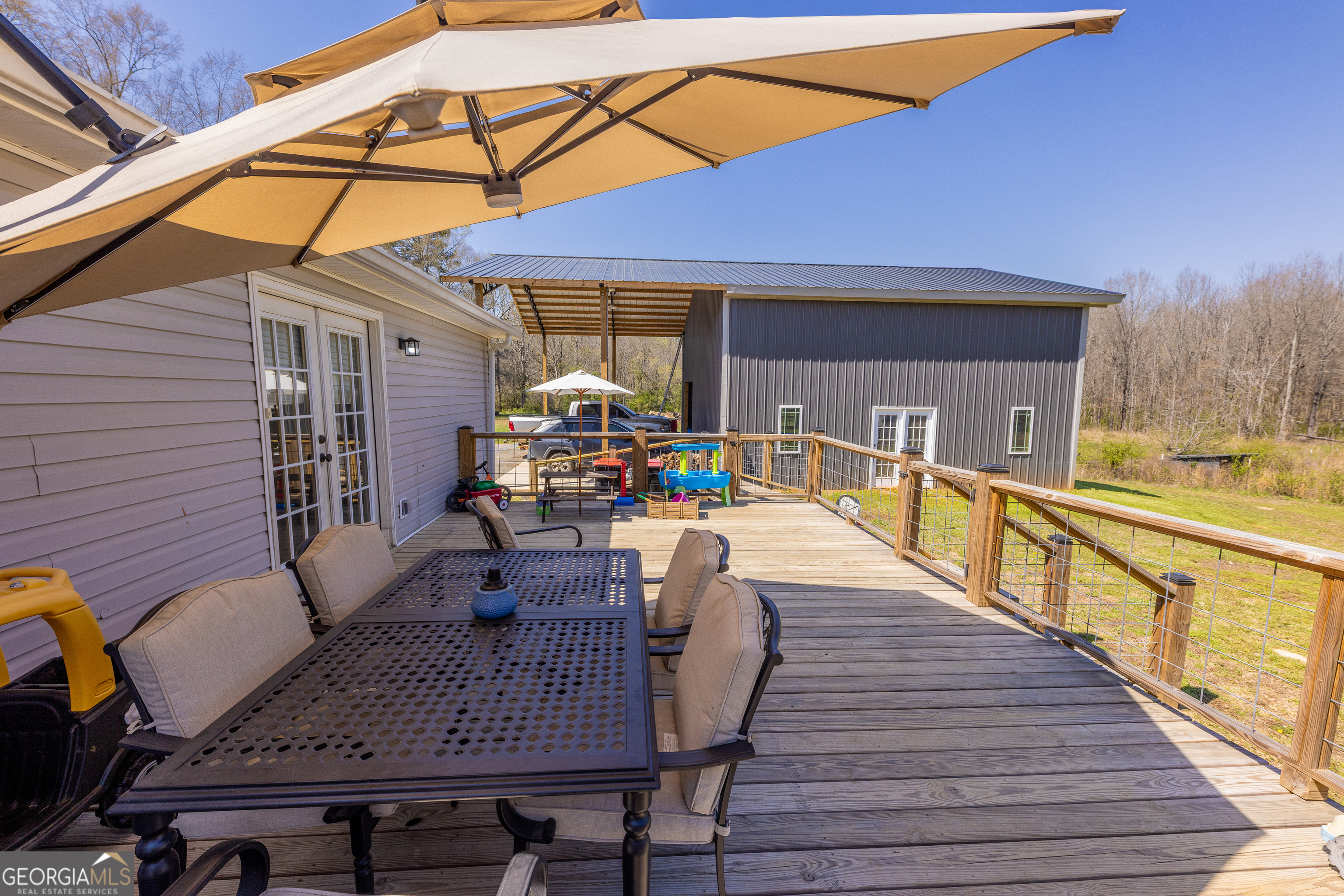 647 Pine Valley Road Meansville, GA 30256 - Photo 27 of 92 a view of a roof deck with dining table and chairs with wooden floor