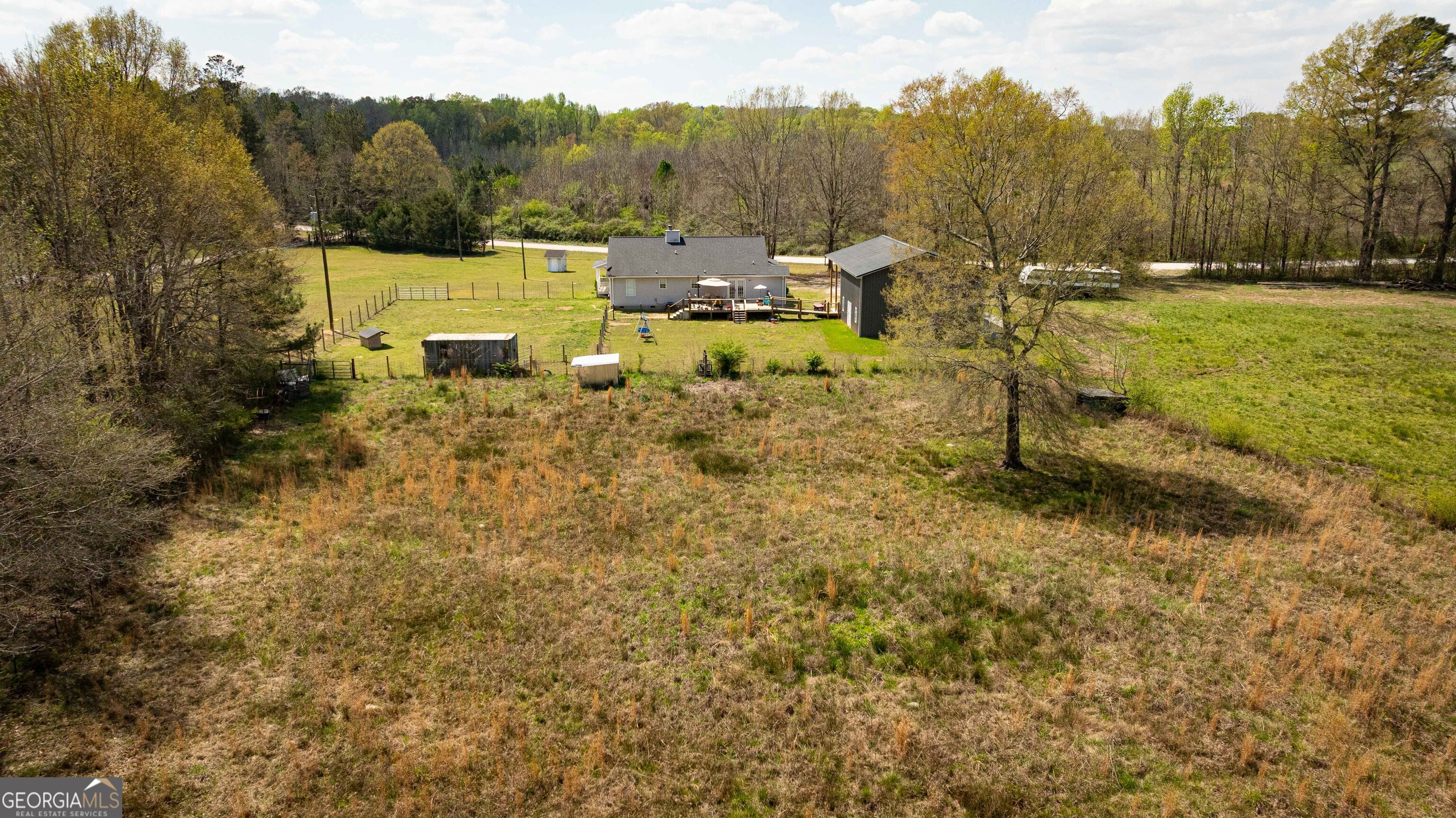 647 Pine Valley Road Meansville, GA 30256 - Photo 55 of 92 a view of a yard with table and chairs