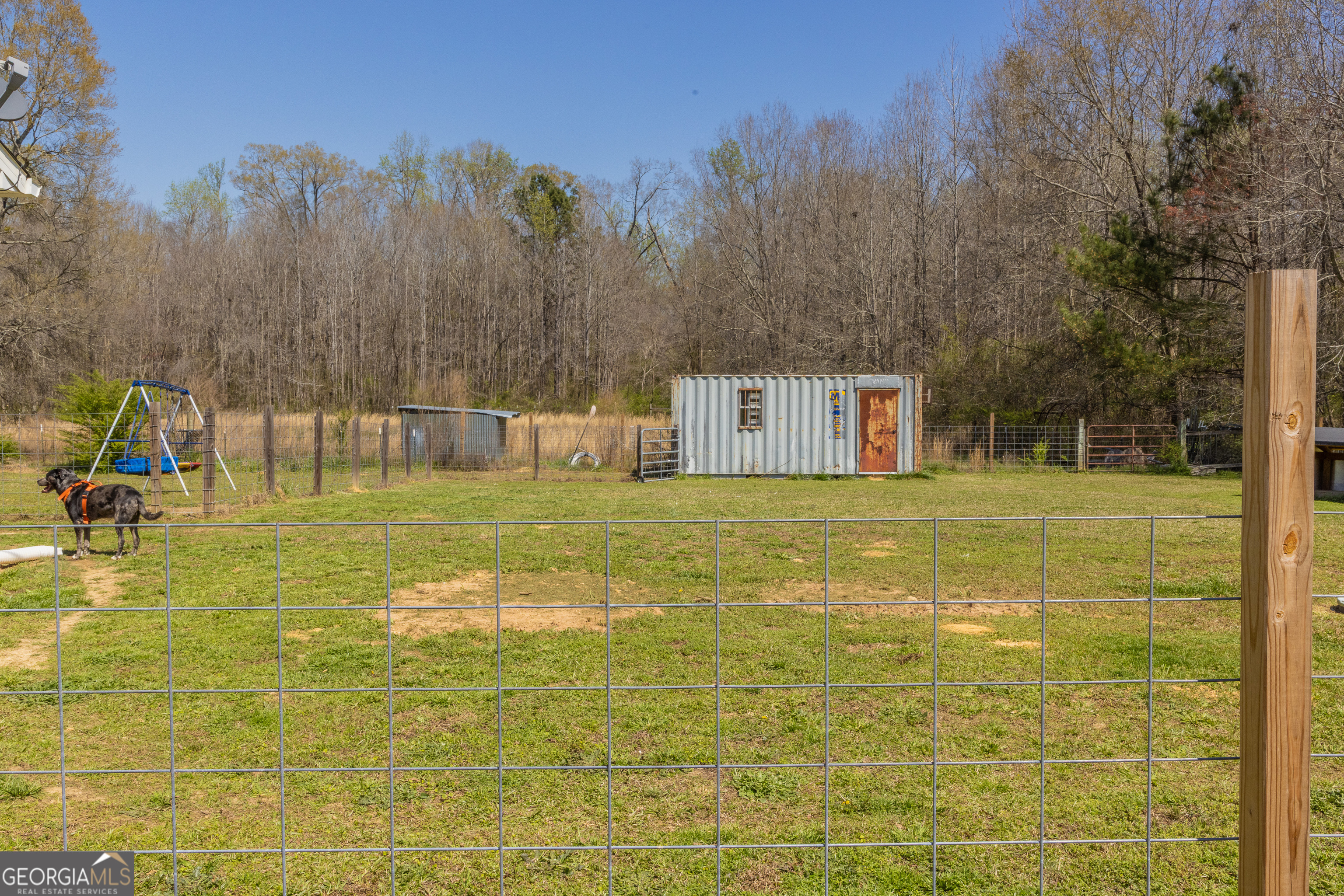 647 Pine Valley Road Meansville, GA 30256 - Photo 75 of 92 a view of a swimming pool with an outdoor space and seating area