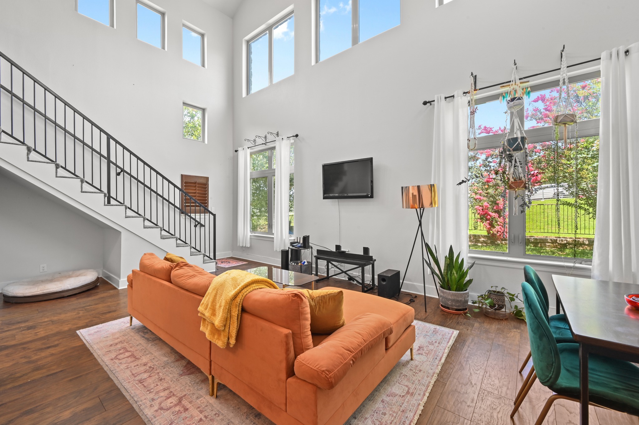 592 Farm To Market 967, Unit B Buda, TX 78610 - Photo 13 of 26 A striking living space boasts a grand staircase, high ceilings, and rich hardwood flooring.