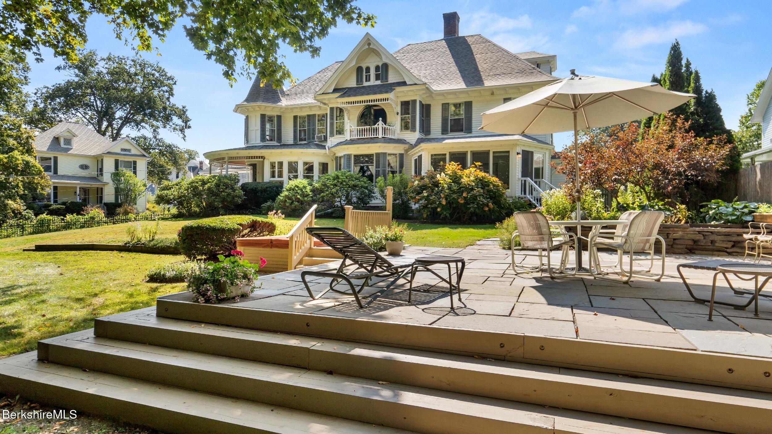 a view of a building with garden and sitting area