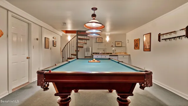 a room with furniture and pool table