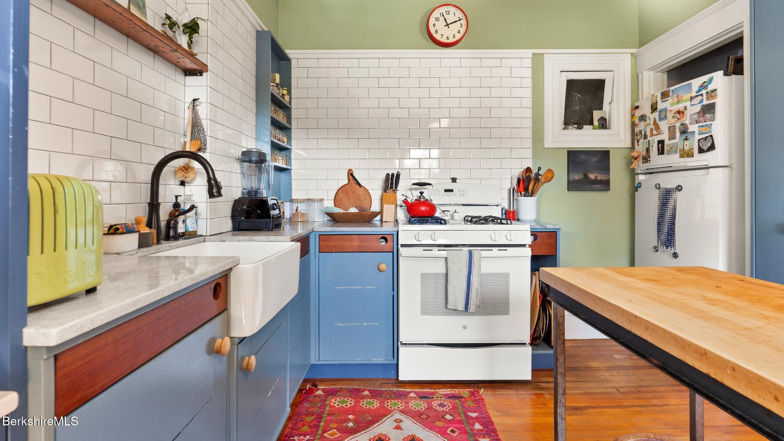 211 Cottage Street Great Barrington, MA 01236 - Photo 28 of 53 a kitchen with stainless steel appliances kitchen island a stove a sink and a refrigerator