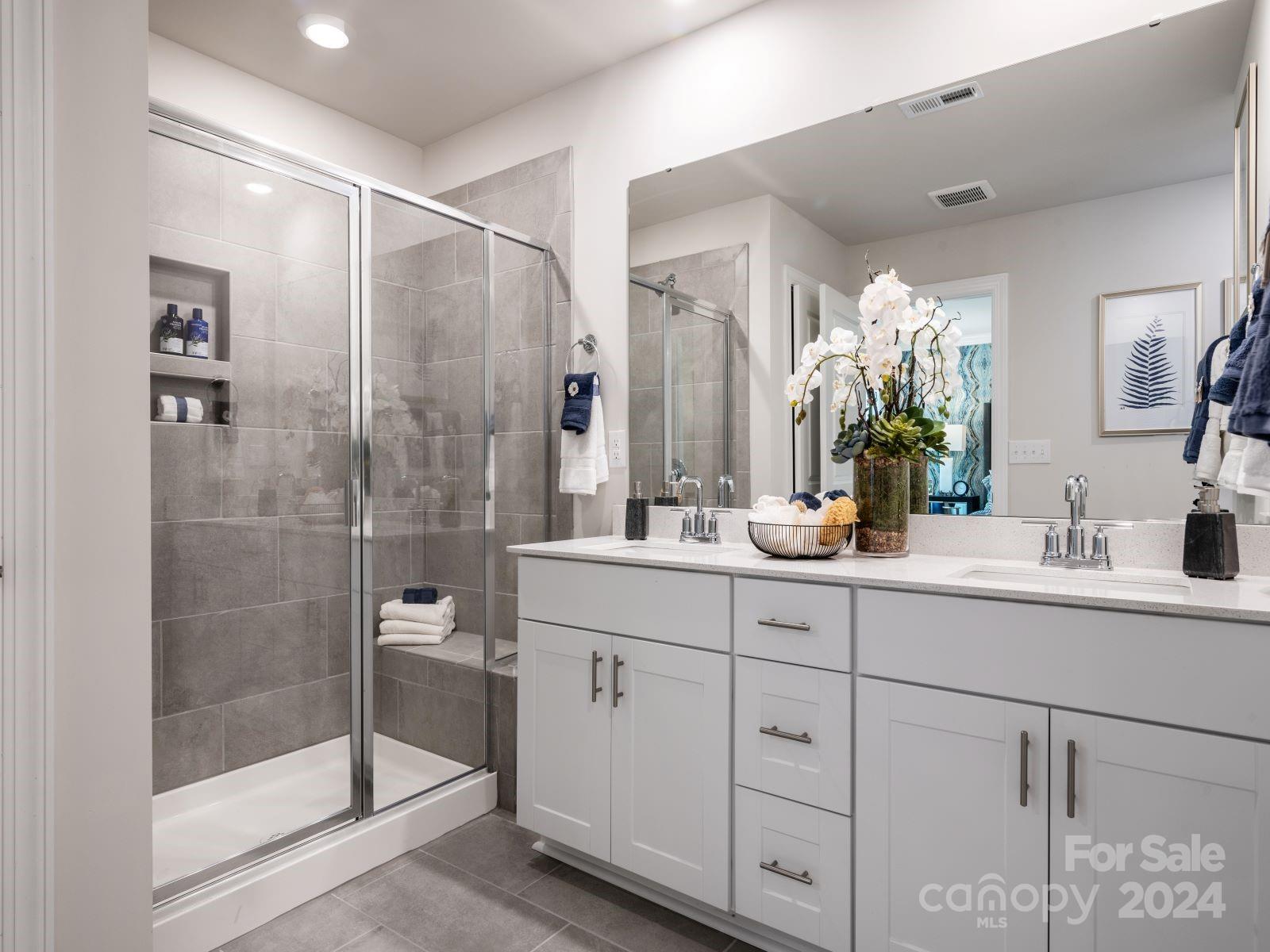 321 Cranford Drive Pineville, NC 28134 - Photo 12 of 14 a bathroom with a shower sink and mirror