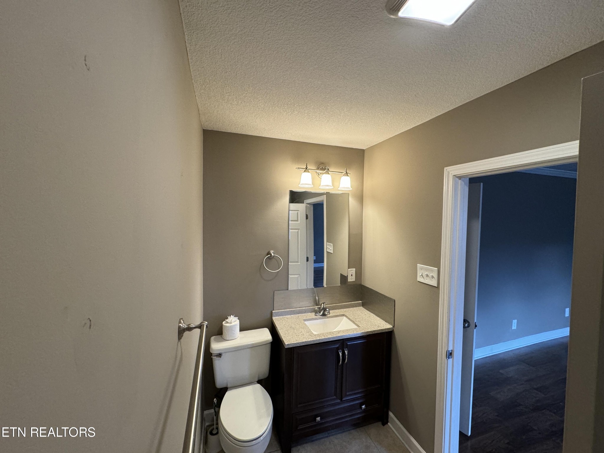 130 East Arrowwood Road Oak Ridge, TN 37830 - Photo 29 of 43 a bathroom with a granite countertop sink toilet and mirror