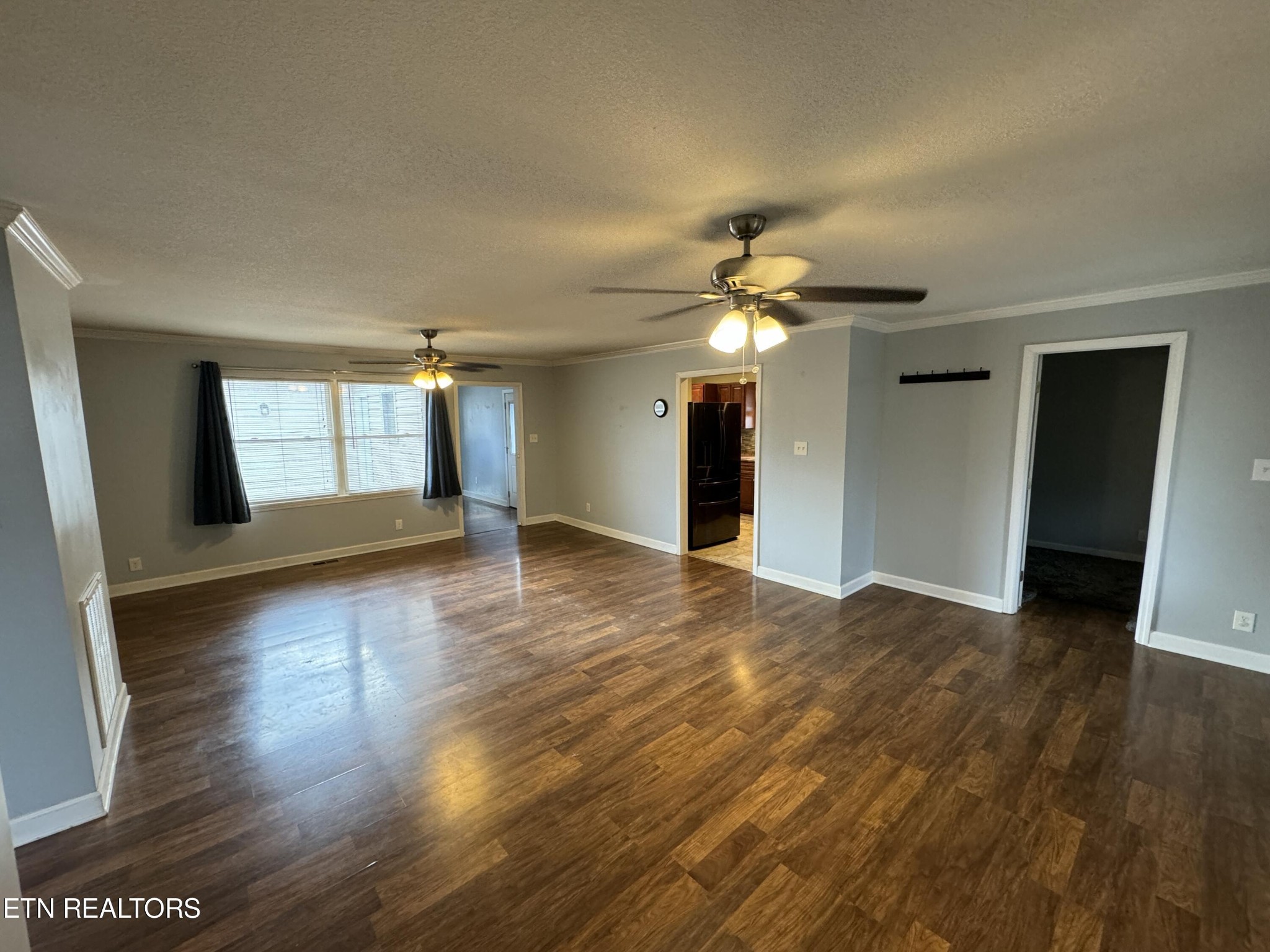 130 East Arrowwood Road Oak Ridge, TN 37830 - Photo 7 of 43 a view of a livingroom with wooden floor and a ceiling fan
