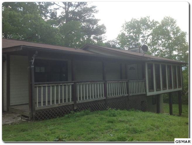 2875 Hatcher Mountain Road Sevierville, TN 37862 - Photo 1 of 1 a view of backyard with wooden fence