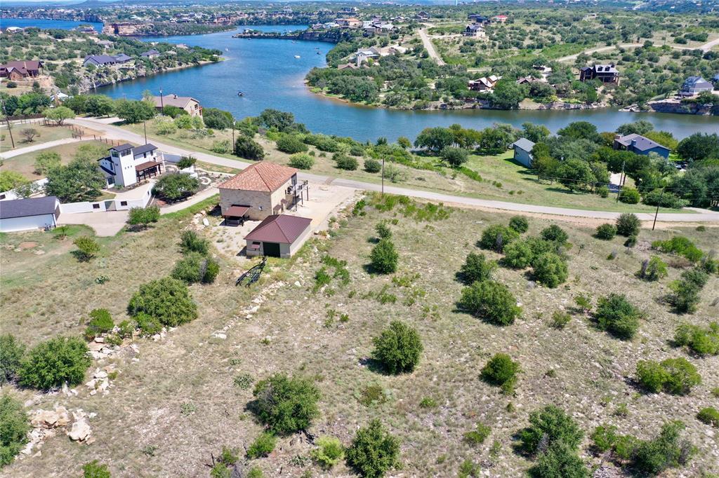 7084 Hells Gate Loop Strawn, TX 76475 - Photo 4 of 12 an aerial view of residential houses with outdoor space