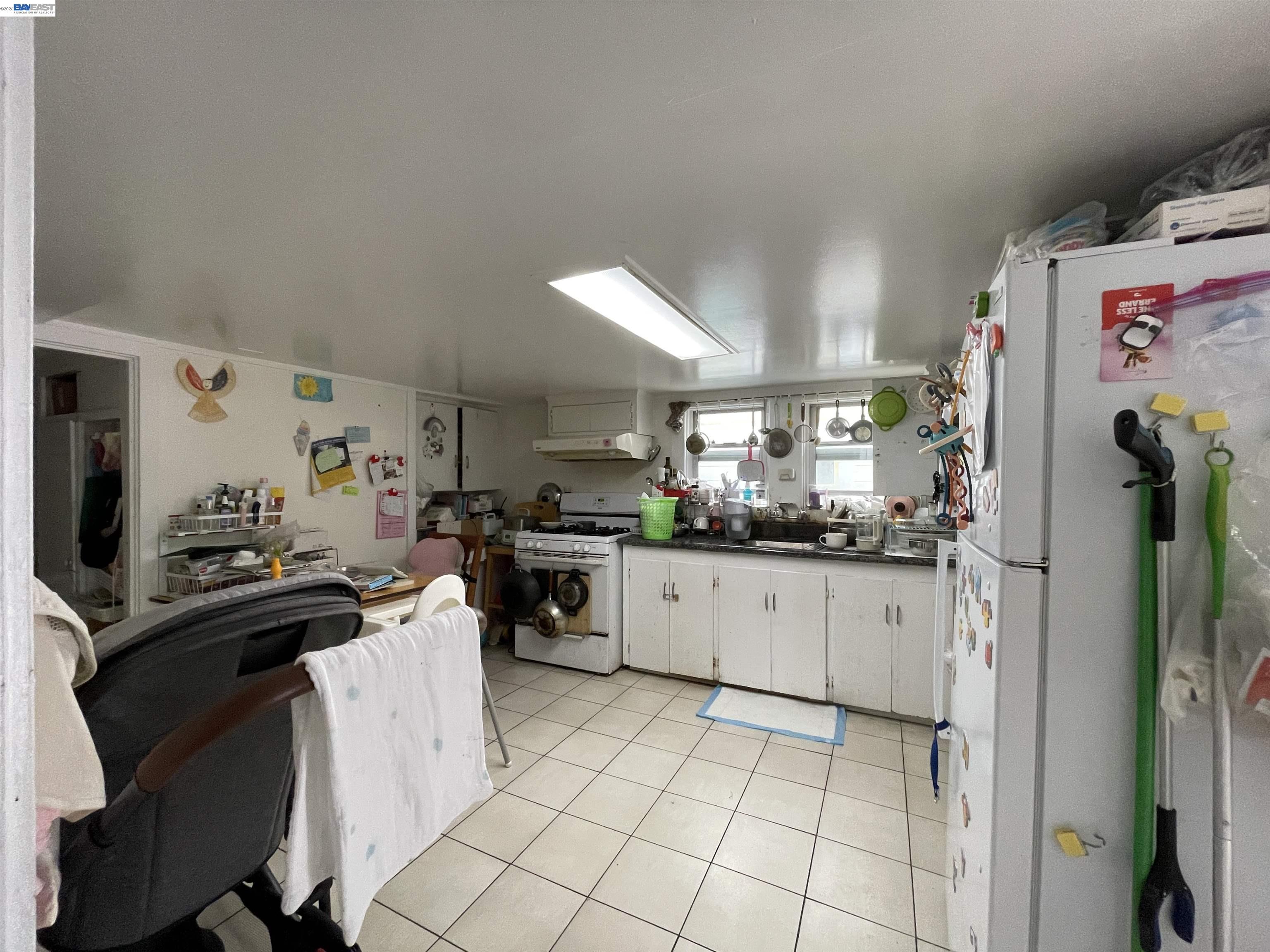 2517 Webb Avenue Alameda, CA 94501 - Photo 11 of 17 a kitchen with a sink a refrigerator and cabinets