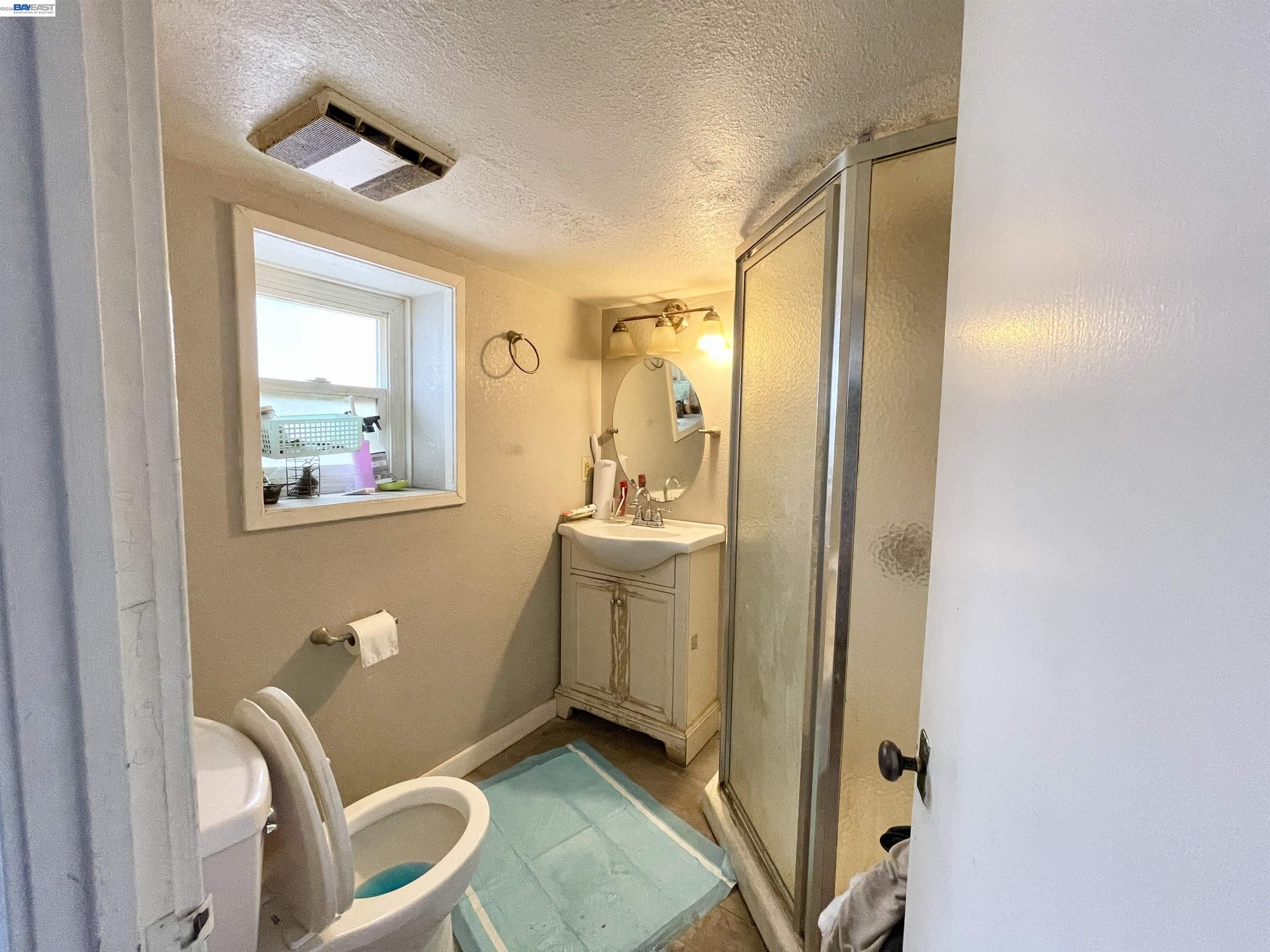 2517 Webb Avenue Alameda, CA 94501 - Photo 14 of 17 a bathroom with a sink a toilet and mirror