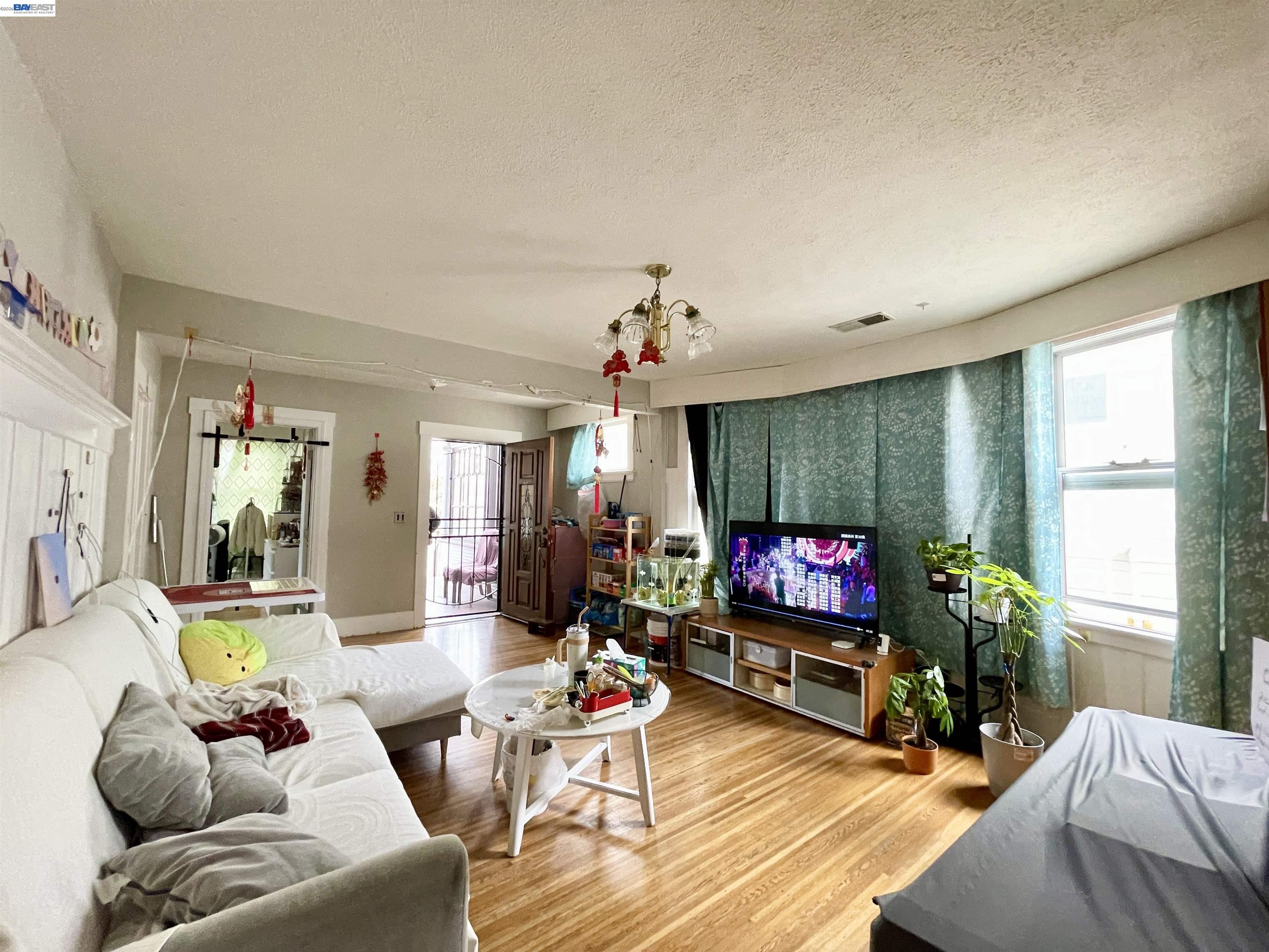 2517 Webb Avenue Alameda, CA 94501 - Photo 2 of 17 a living room with furniture a flat screen tv and a large window