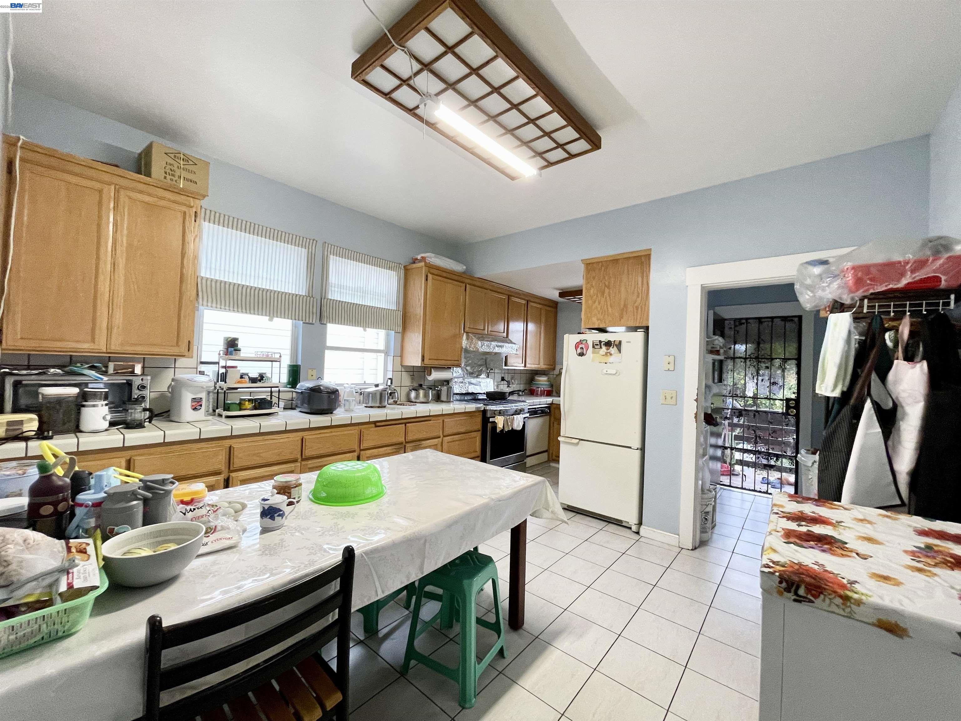 2517 Webb Avenue Alameda, CA 94501 - Photo 3 of 17 a room with stainless steel appliances lots of wooden furniture and large windows