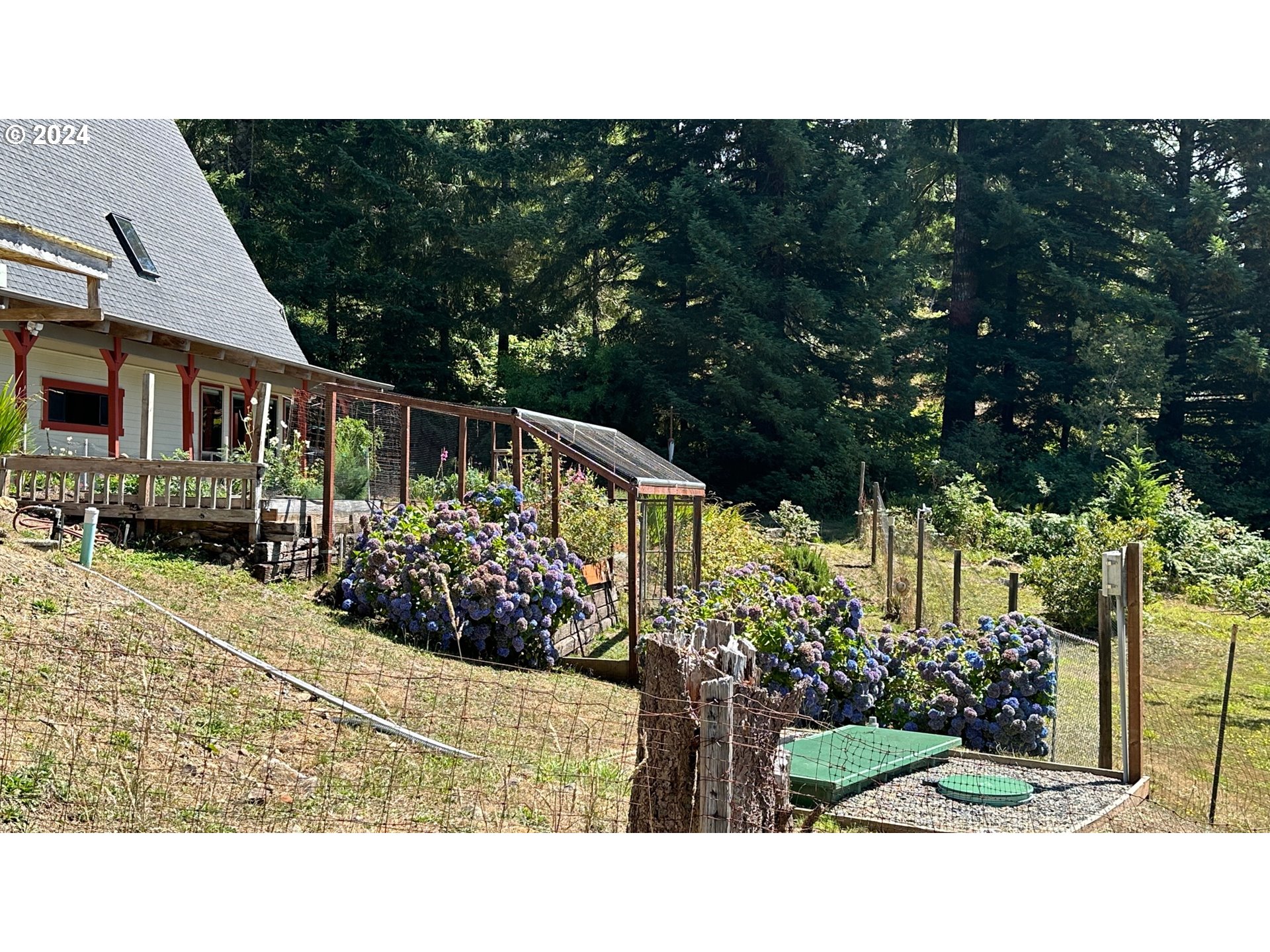 18730 Carpenterville Road Brookings, OR 97415 - Photo 3 of 48 a view of house and garden