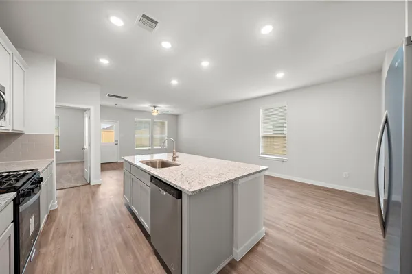 a kitchen with a stove a sink and a refrigerator