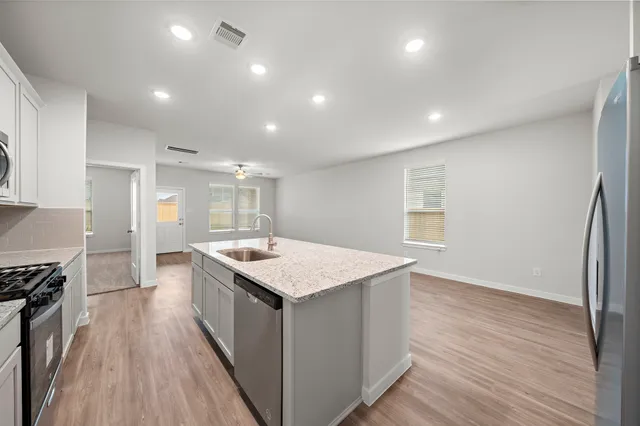 a kitchen with a stove a sink and a refrigerator