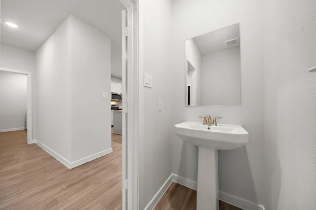 a bathroom with a sink a mirror and shower