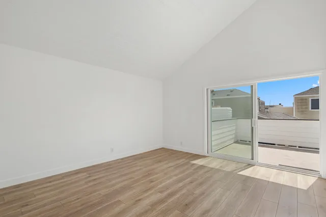 a view of an empty room and wooden floor