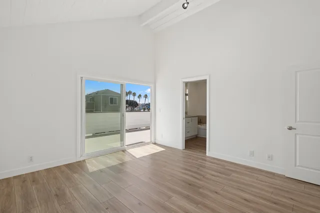 a view of a room with wooden floor