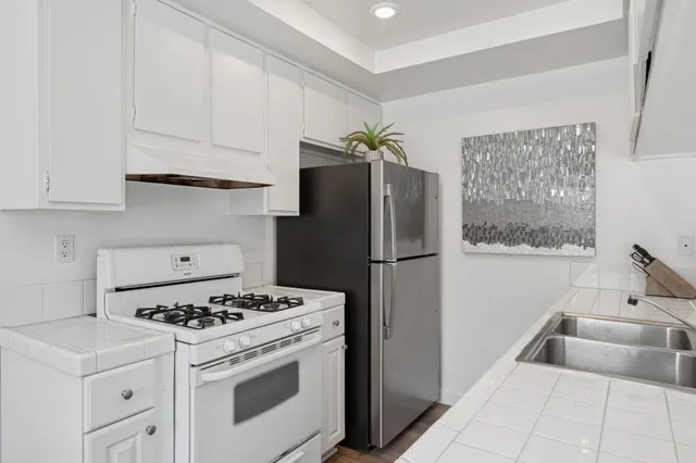 a kitchen with a stove and a refrigerator