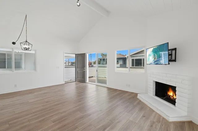 a view of an empty room with a fireplace and a window