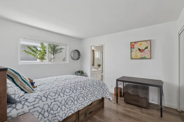 a bedroom with a bed and a chair