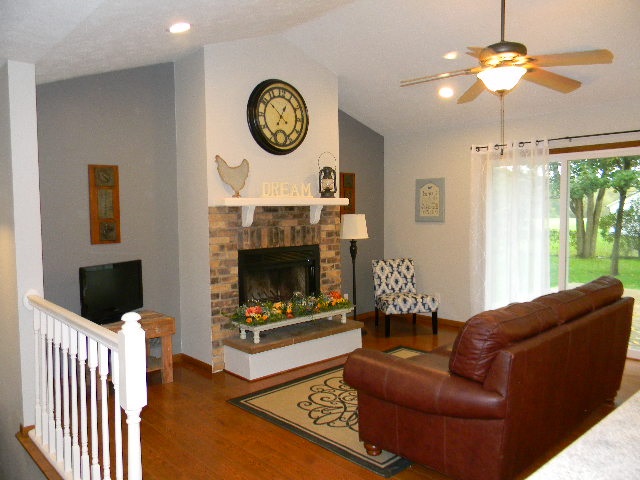 4193 Briargate Road Rockford, IL 61102 - Photo 3 of 25 a living room with furniture a flat screen tv and a fireplace