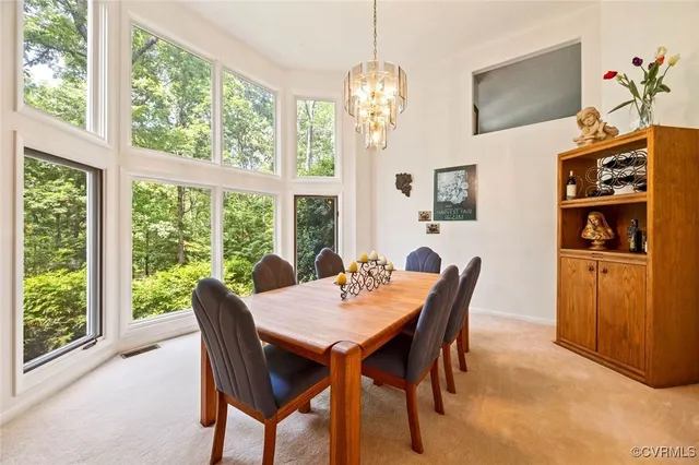 a view of a dining room with furniture window and outside view