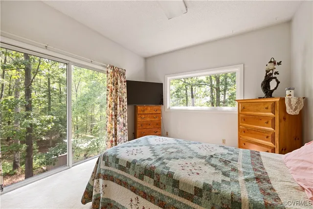 a bedroom with a bed next to a window