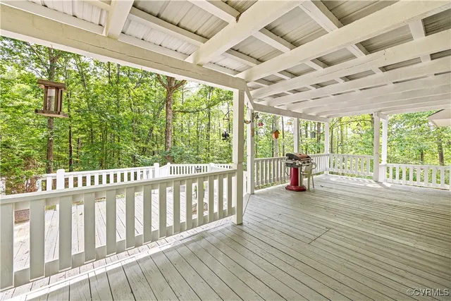 a view of a wooden deck and backyard