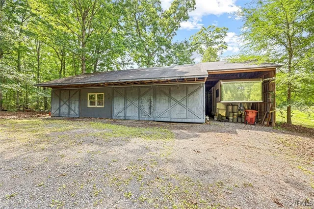 a view of a house with a yard and tree