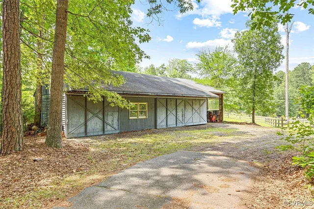 a view of a yard with plants and trees