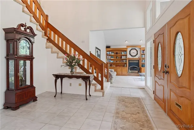 a view of staircase with lots of frames on wall and a large window