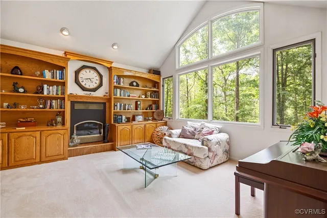 a bedroom with furniture and a large window