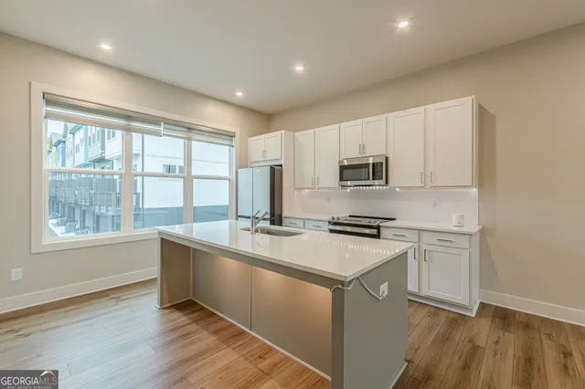 a kitchen with a stove a sink and a refrigerator