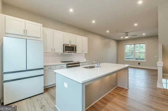a kitchen with a sink stove and cabinets