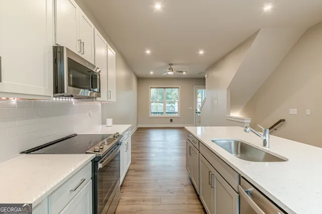 a kitchen with granite countertop a stove and a microwave