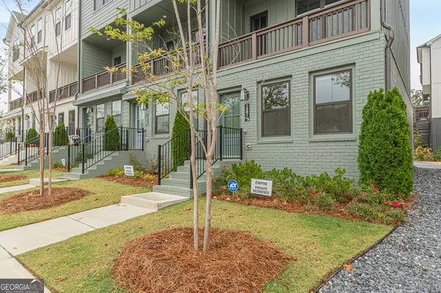 front view of a brick house with a yard