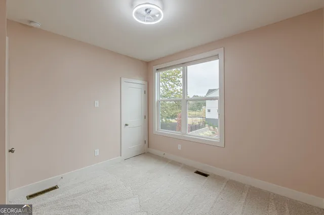 a view of a room with air conditioner and a living room